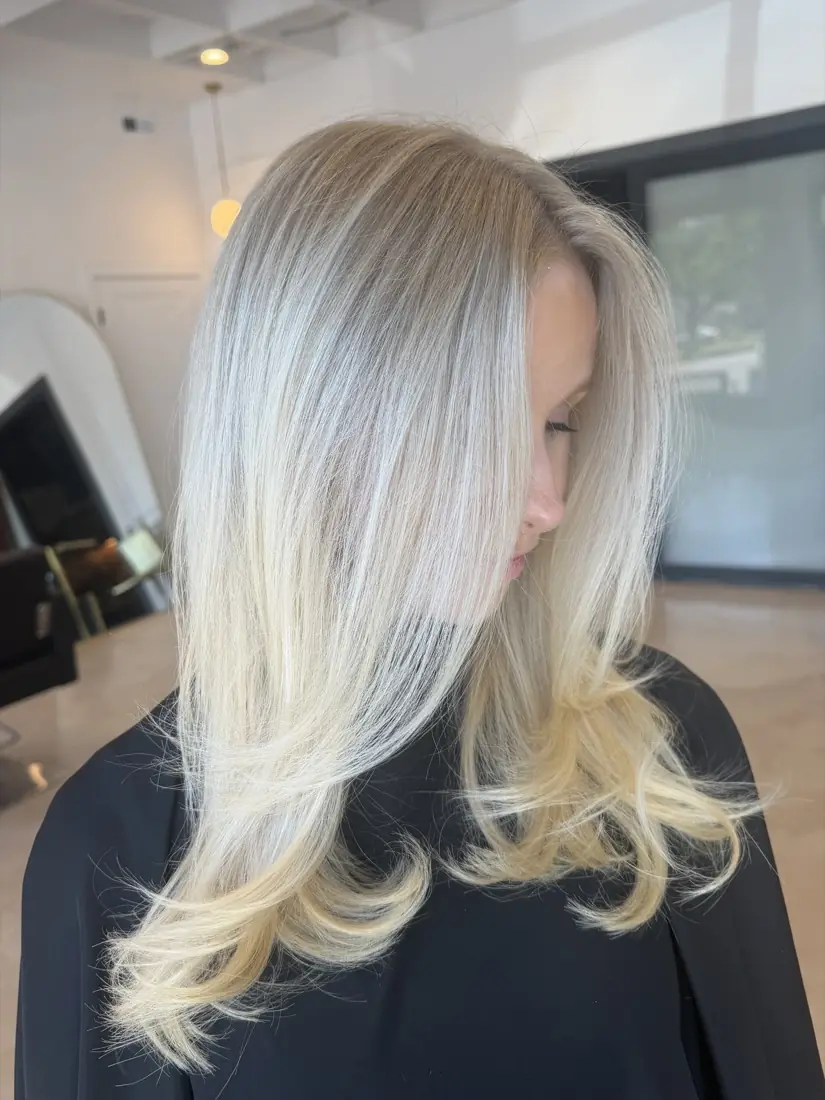 Icy platinum with softly curled ends, seen in side profile.