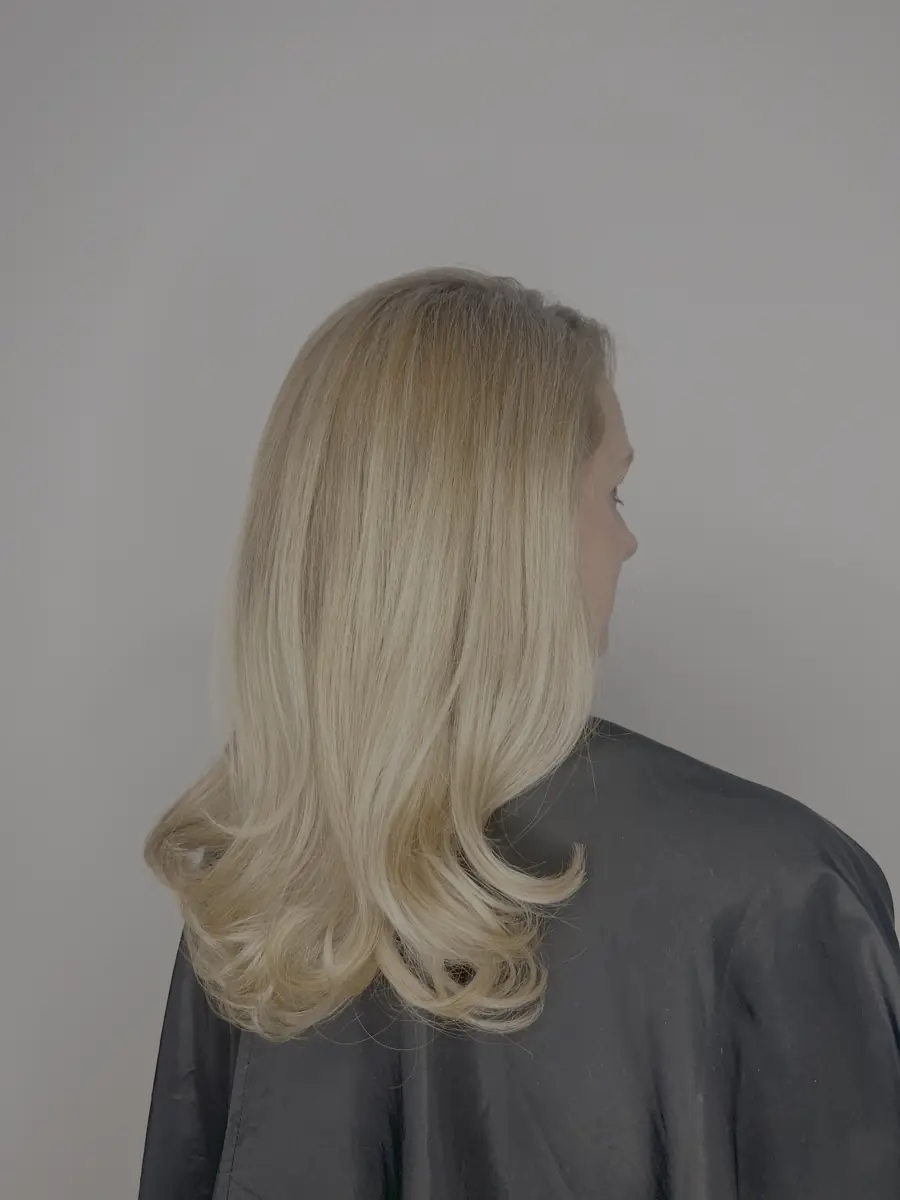 Soft blonde blowout with curled ends, finished in the chair.